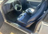Drivers seat with the door open. The seat and dashboard are blue.