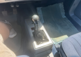 Center floorboard showing a stick shift.