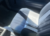 Interior blue passenger seat, blue door panel, and blue carpet.