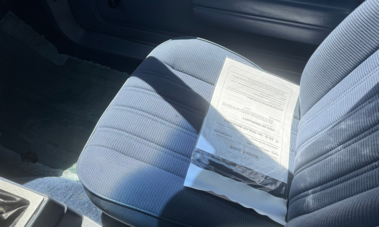 Interior blue passenger seat, blue door panel, and blue carpet.
